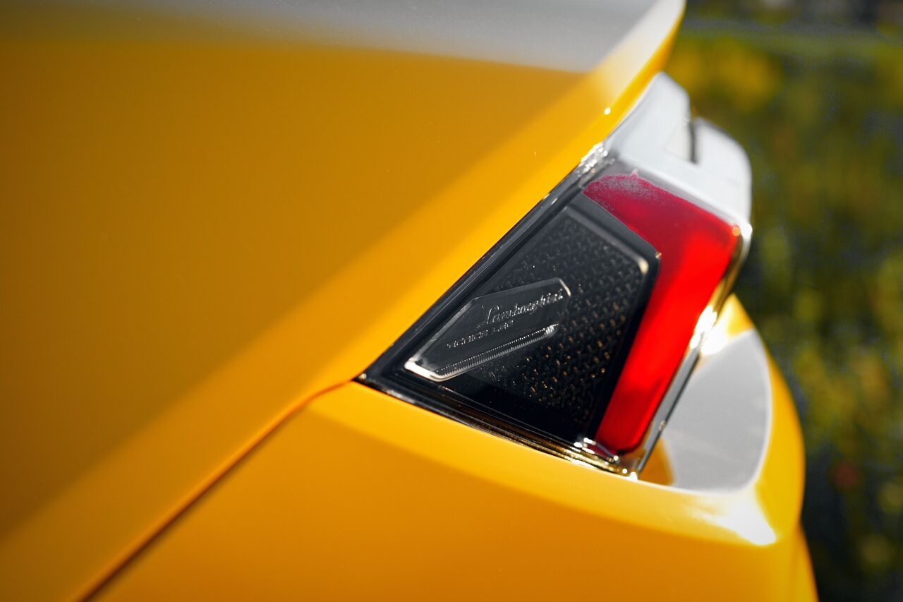Detalhe da lateral traseira amarela de um Lamborghini Urus